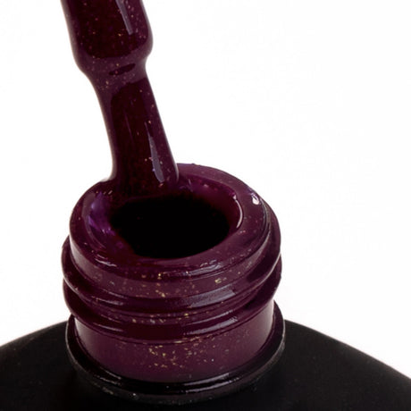 Close-up of SPN Nails UV/LED Gel Polish 596 Whisper showing a glittery purple-red gel formula on the brush, ideal for hybrid nails.