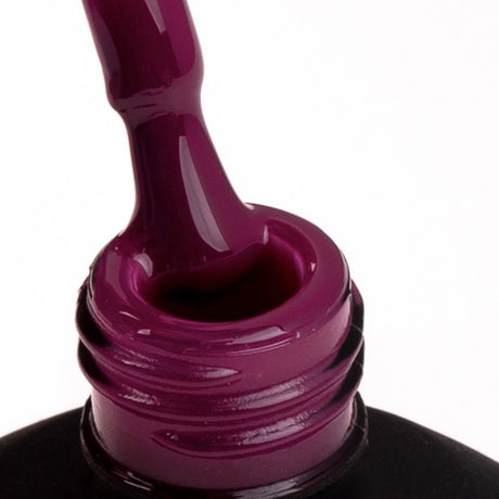 Close-up of SPN Nails UV/LED Gel Polish 810 Friday's Euphoria showing its rich, glossy red-purple gel texture being applied.