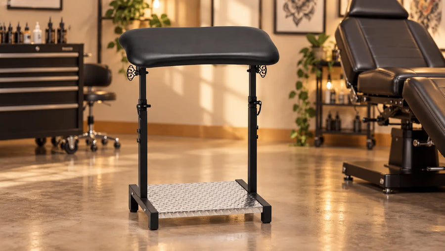 Pro Ink 720 black tattoo armrest with twin uprights and metal foot platform in an illustrative studio setting