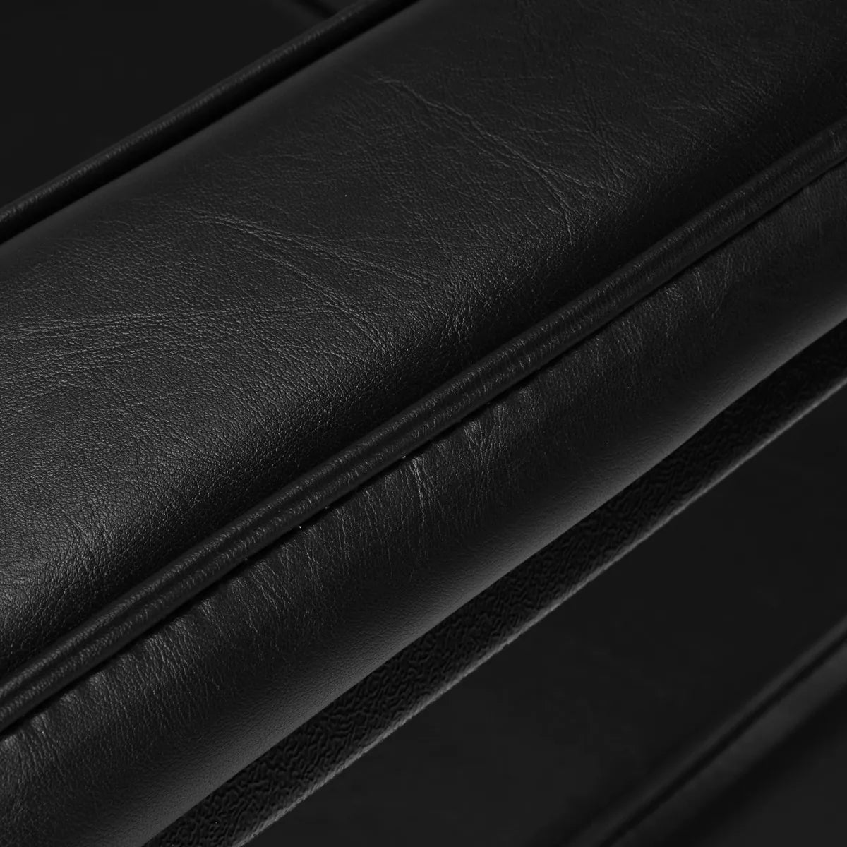 Close-up of Pro Ink 604 Electric Tattoo Chair Black armrest padding, emphasizing its premium leather finish and comfort.