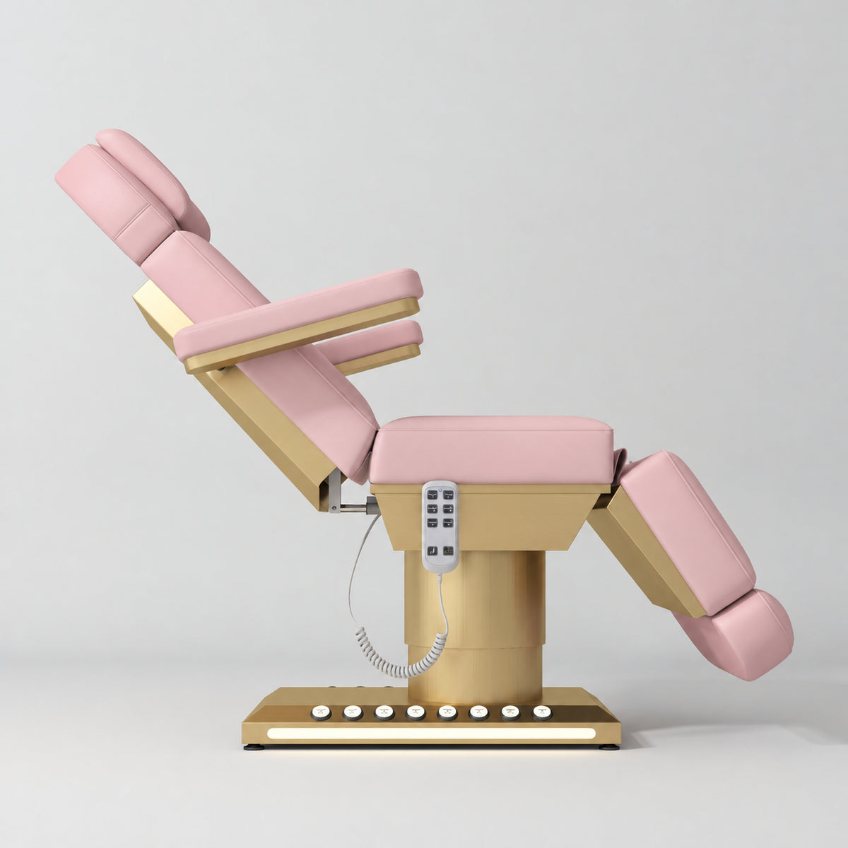 Manufakturo Aurélie beauty bed in Bare Blush with gold-finished base, side view with backrest raised and leg section lowered.