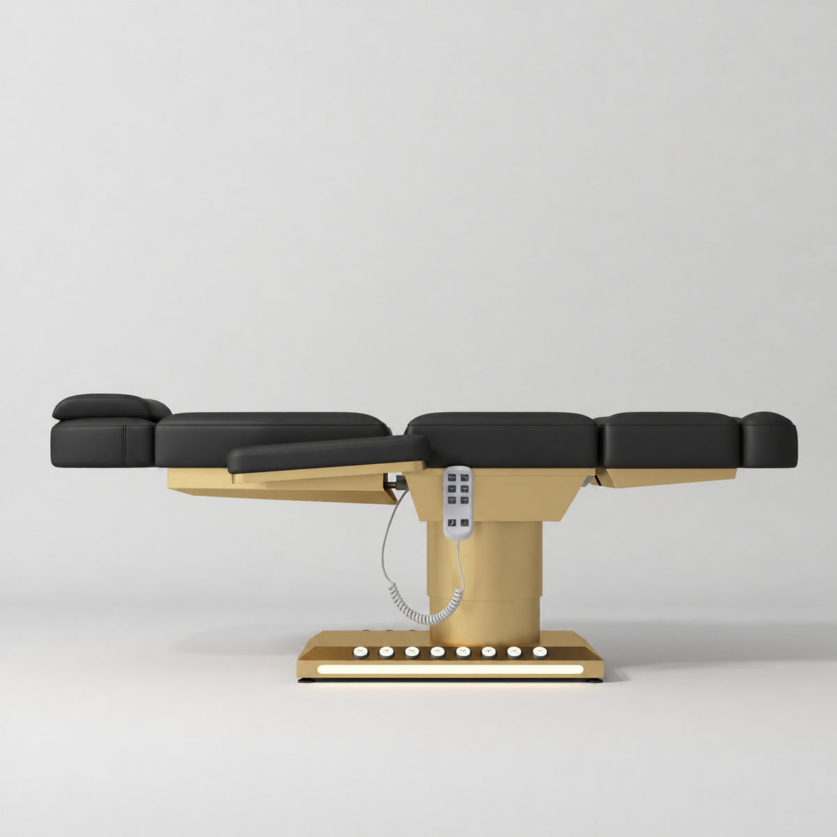 Manufakturo Aurélie beauty bed in Black with gold-finished base, flat side view.