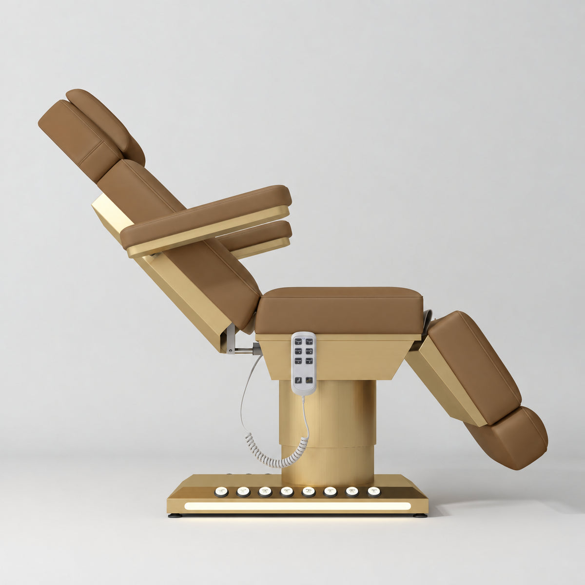 Manufakturo Aurélie beauty bed in Caramel with gold-finished base, side view with backrest raised and leg section lowered.