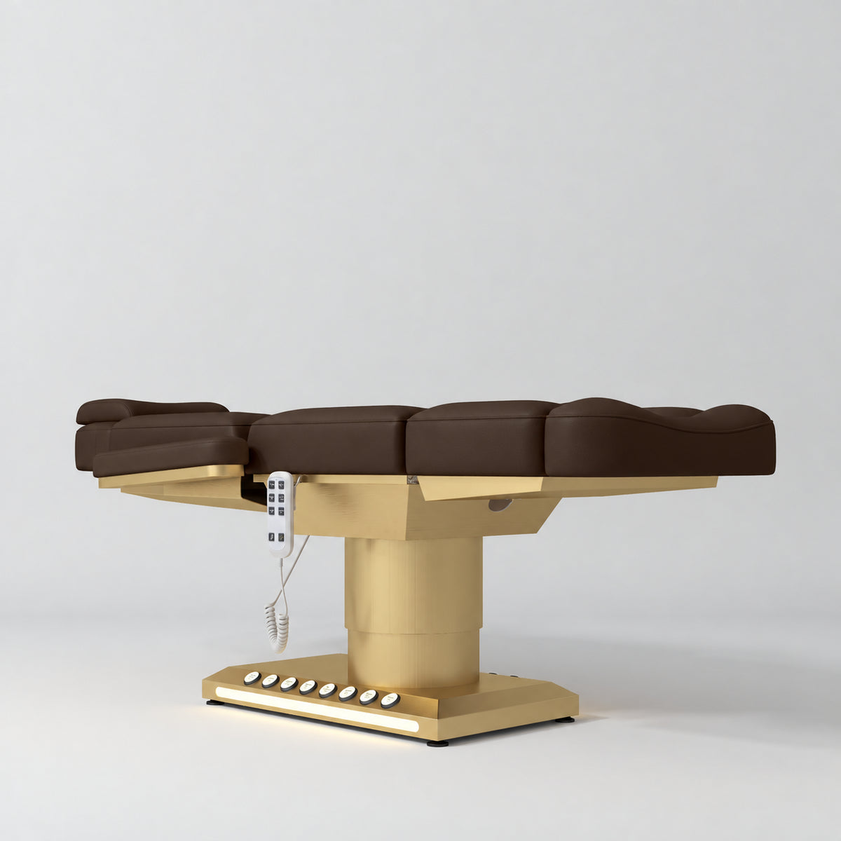 Manufakturo Aurélie beauty bed in Cocoa Mocha with gold-finished base, flat low-angle view.