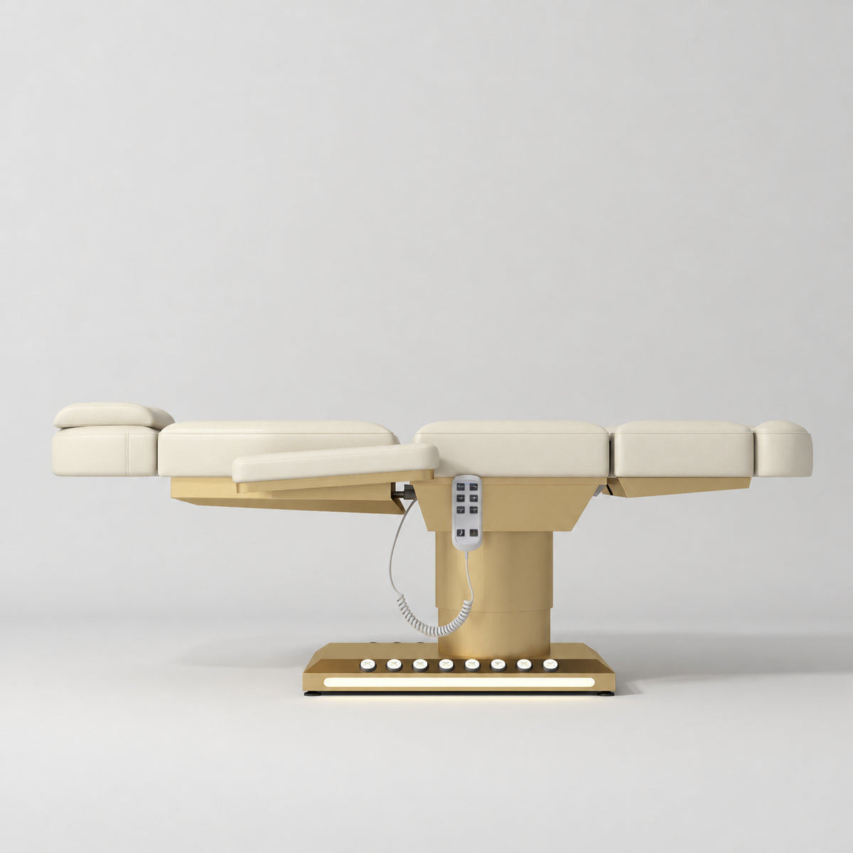 Manufakturo Aurélie beauty bed in Creamy with gold-finished base, flat side view.