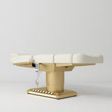 Manufakturo Aurélie beauty bed in Creamy with gold-finished base, flat low-angle view.