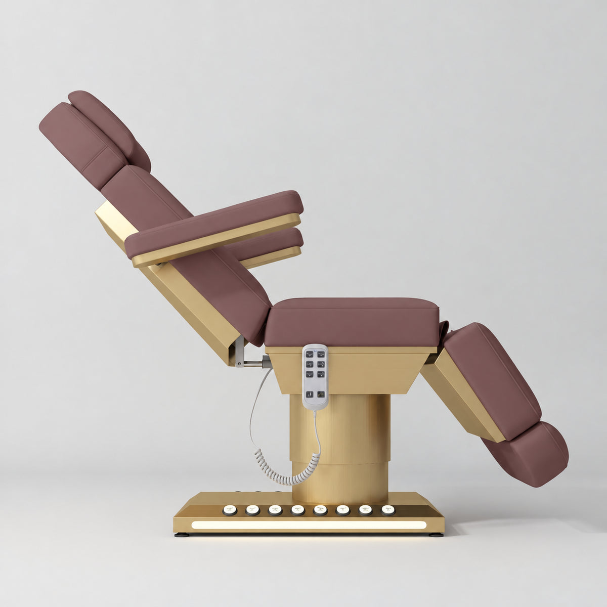 Manufakturo Aurélie beauty bed in Dusty Rose with gold-finished base, side view with backrest raised and leg section lowered.