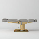 Manufakturo Aurélie beauty bed in Pearl Greige with gold-finished base, flat side view.