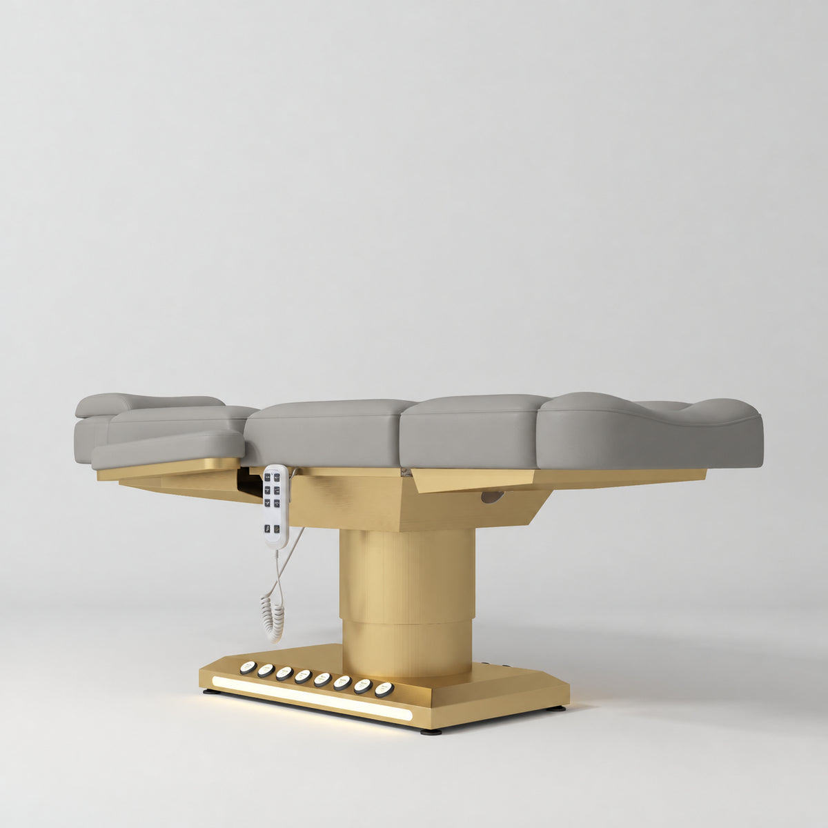 Manufakturo Aurélie beauty bed in Pearl Greige with gold-finished base, flat low-angle view.