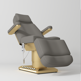 Manufakturo Aurélie beauty bed in Deep Ash with gold-finished base, reclined front three-quarter view.