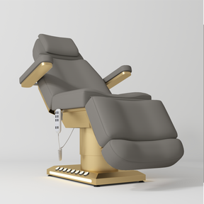 Manufakturo Aurélie beauty bed in Deep Ash with gold-finished base, reclined front three-quarter view.