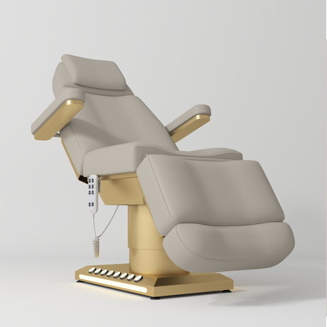 Manufakturo Aurélie beauty bed in Stone Taupe with gold-finished base, reclined front three-quarter view.