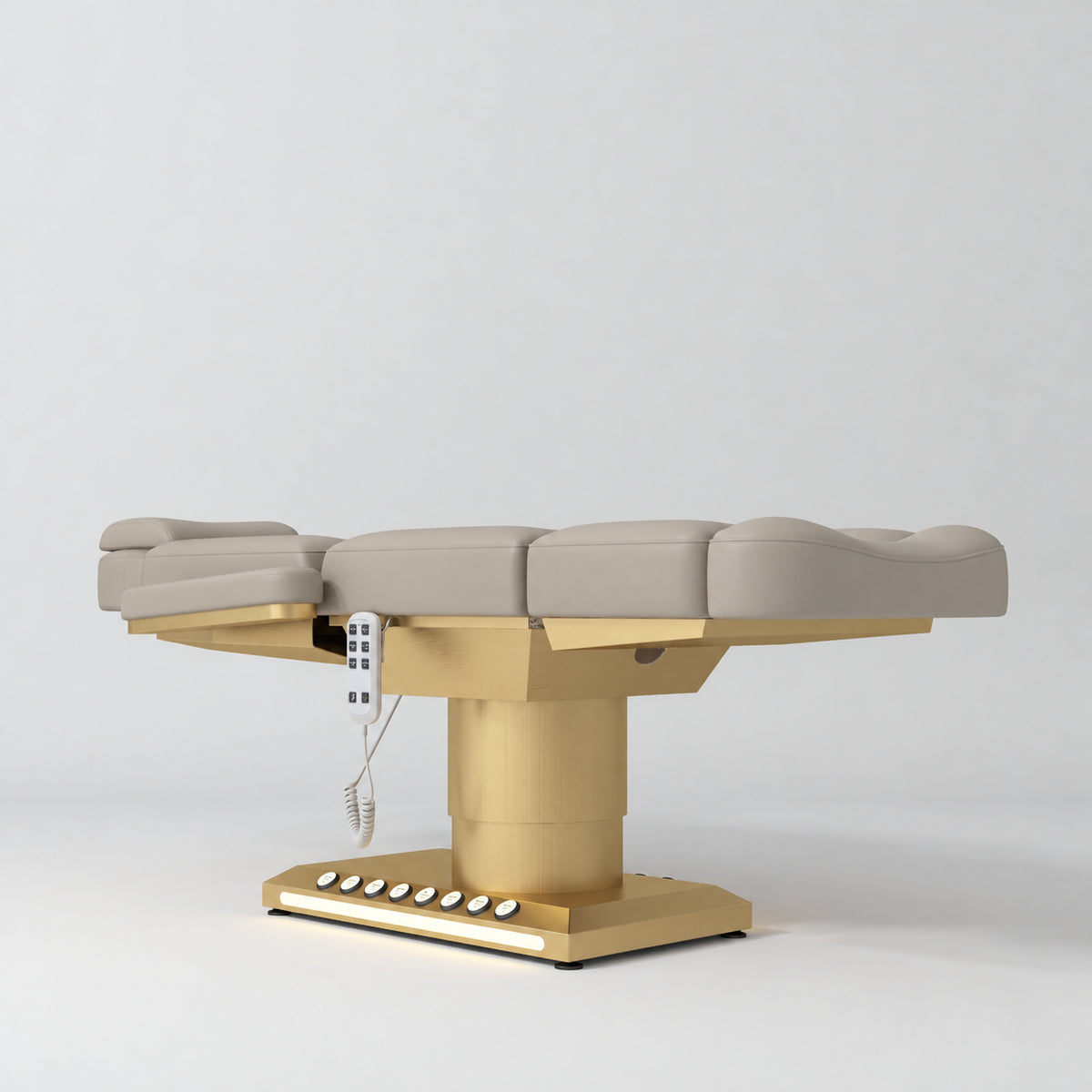 Manufakturo Aurélie beauty bed in Stone Taupe with gold-finished base, flat low-angle view.