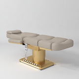 Manufakturo Aurélie beauty bed in Stone Taupe with gold-finished base, flat view from above at an angle.