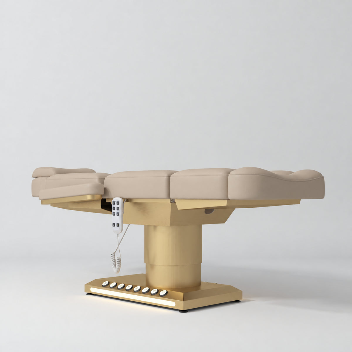 Manufakturo Aurélie beauty bed in Warm Beige with gold-finished base, flat low-angle view.