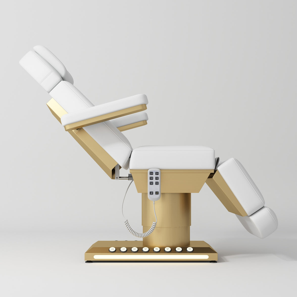 Manufakturo Aurélie beauty bed in White with gold-finished base, side view with backrest raised and leg section lowered.