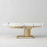 Manufakturo Aurélie beauty bed in White with gold-finished base, flat side view.