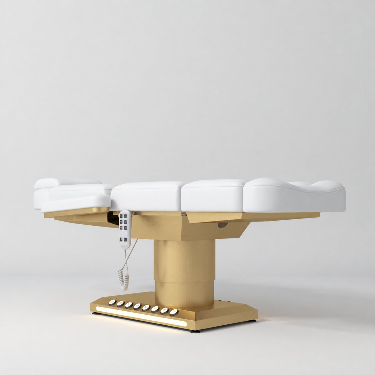 Manufakturo Aurélie beauty bed in White with gold-finished base, flat low-angle view.