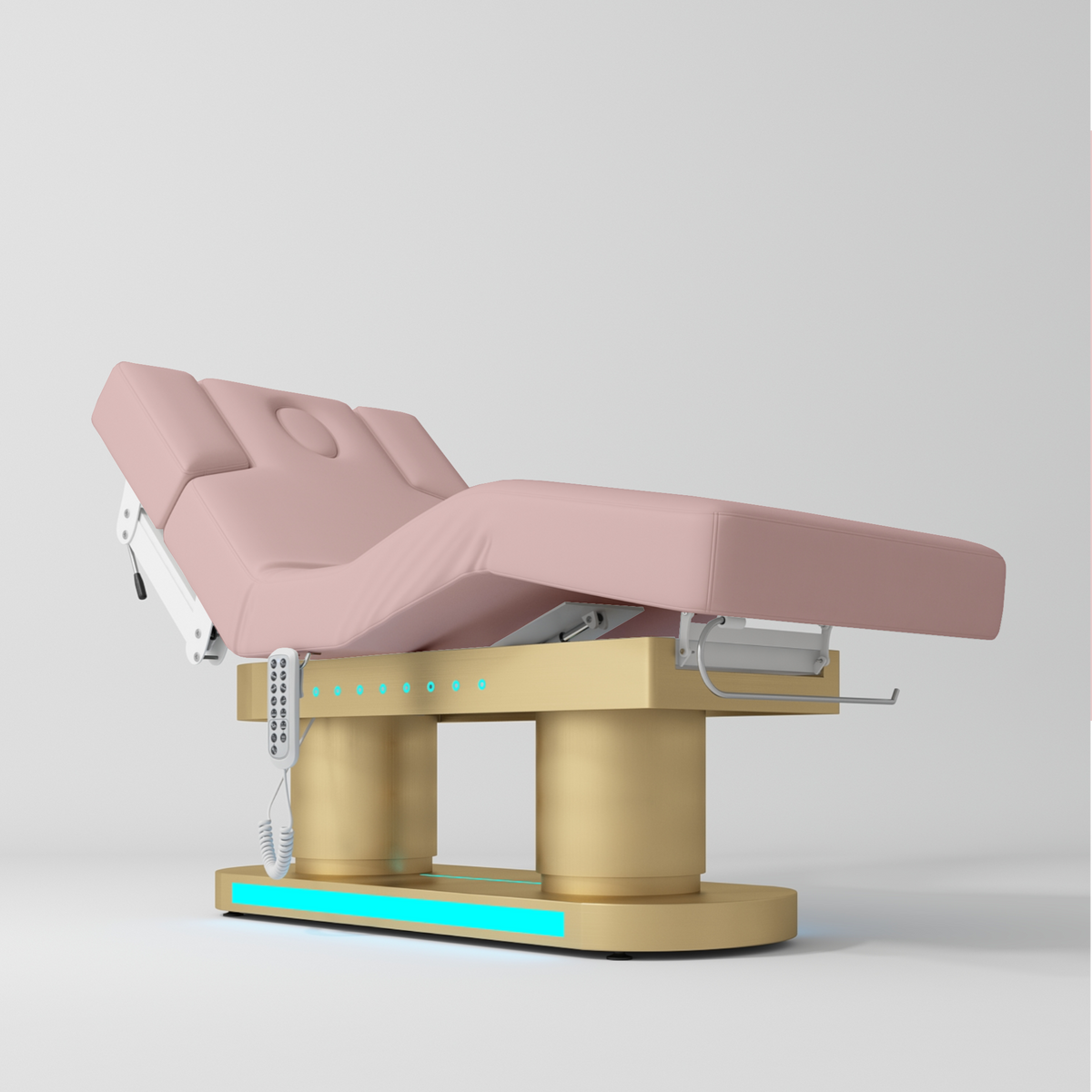 An adjustable medical examination table with a light pink padded surface, mounted on a gold-colored base with white control components and a turquoise LED light strip, shown on a light gray background.