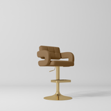 Manufakturo Mirae bar stool in Caramel with a panelled backrest, upholstered armrests and a gold-finished pedestal base and footrest