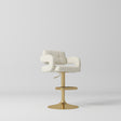 Manufakturo Mirae bar stool in Creamy with a panelled backrest, upholstered armrests and a gold-finished pedestal base and footrest