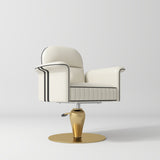 A modern salon chair with cream-colored leather upholstery, black piping details, and a metallic gold pedestal base on a light gray background.