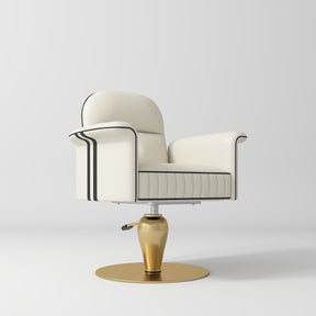 A modern salon chair with cream-colored leather upholstery, black piping details, and a metallic gold pedestal base on a light gray background.