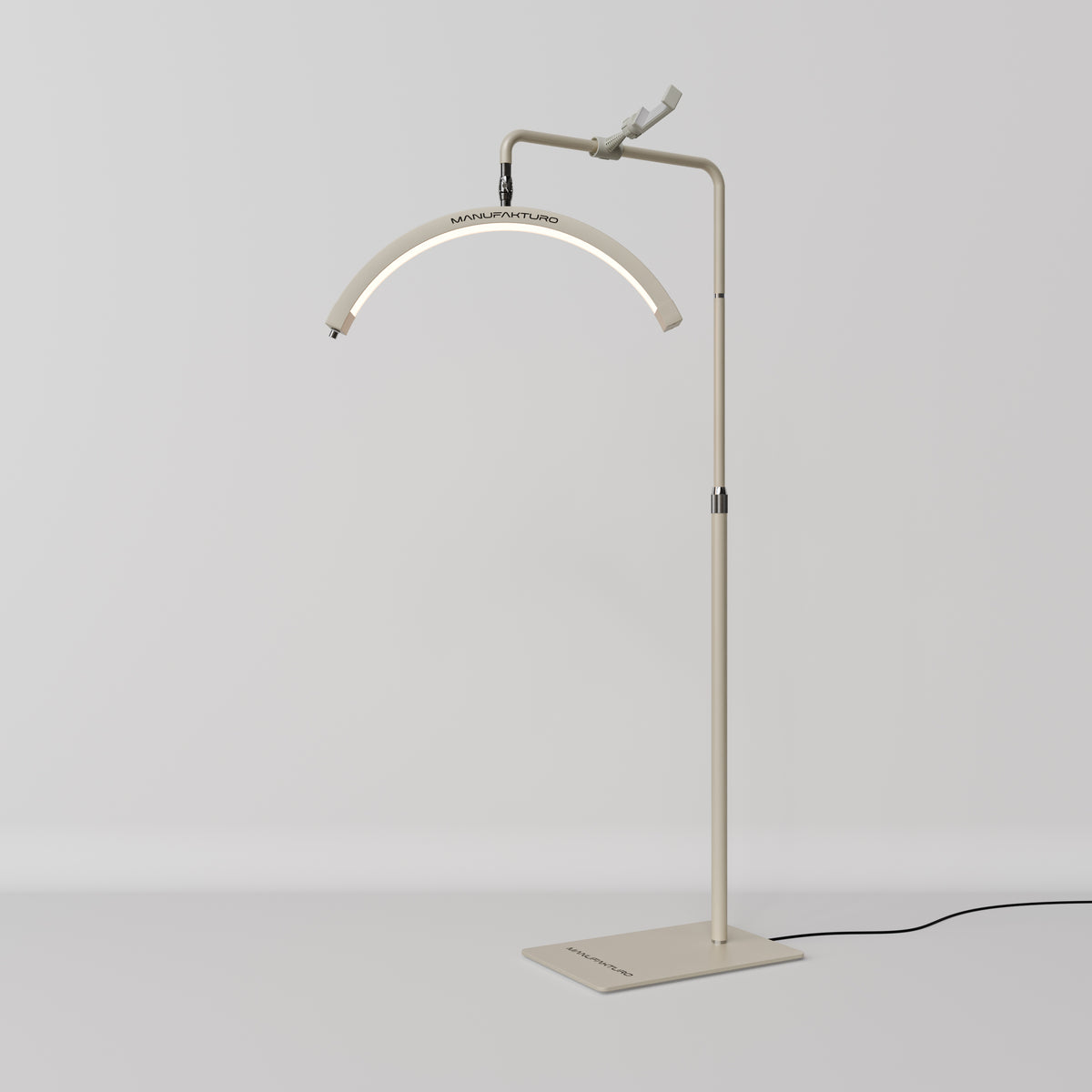 A modern floor lamp with an adjustable metal stand, a curved light bar, and a black power cord, shown against a neutral light gray background.