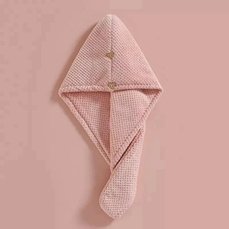 Pink microfiber hair towel with a button closure, suitable for quick drying and gentle care of high porosity hair.