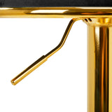 a close up of a gold metal table with a black top