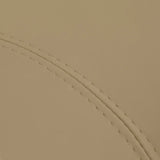 Close-up of beige faux leather upholstery and stitching