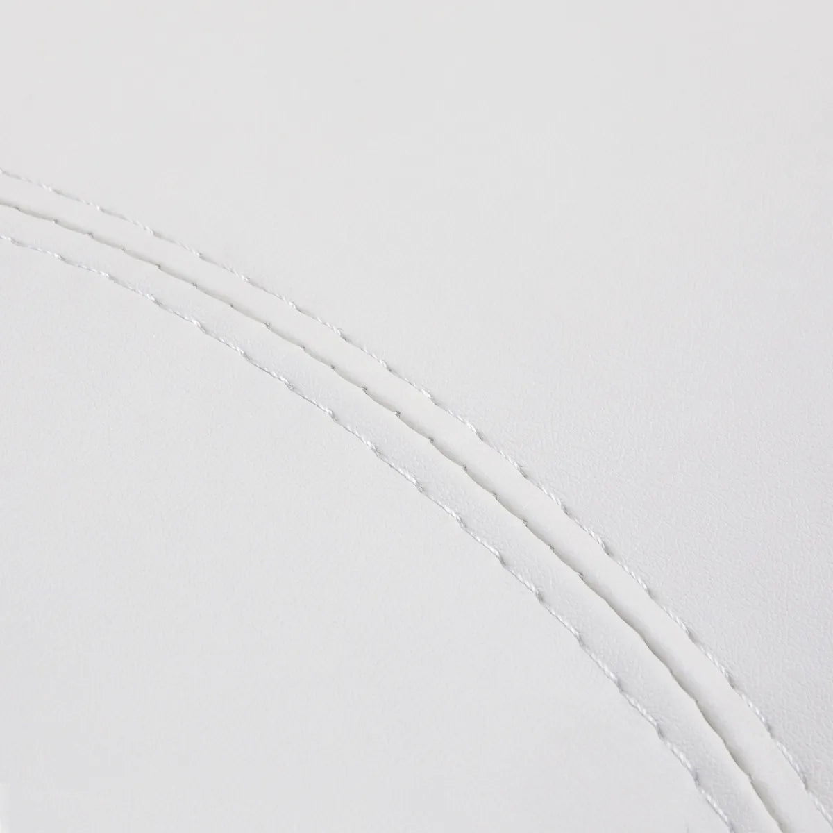 Close-up of the snow-white faux leather upholstery and stitching