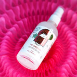 Crazy Hair Heat Protection Spray Pink Grapefruit - product displayed with its packaging on a dark background