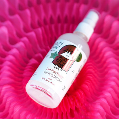 Crazy Hair Heat Protection Spray Pink Grapefruit - product displayed with its packaging on a dark background