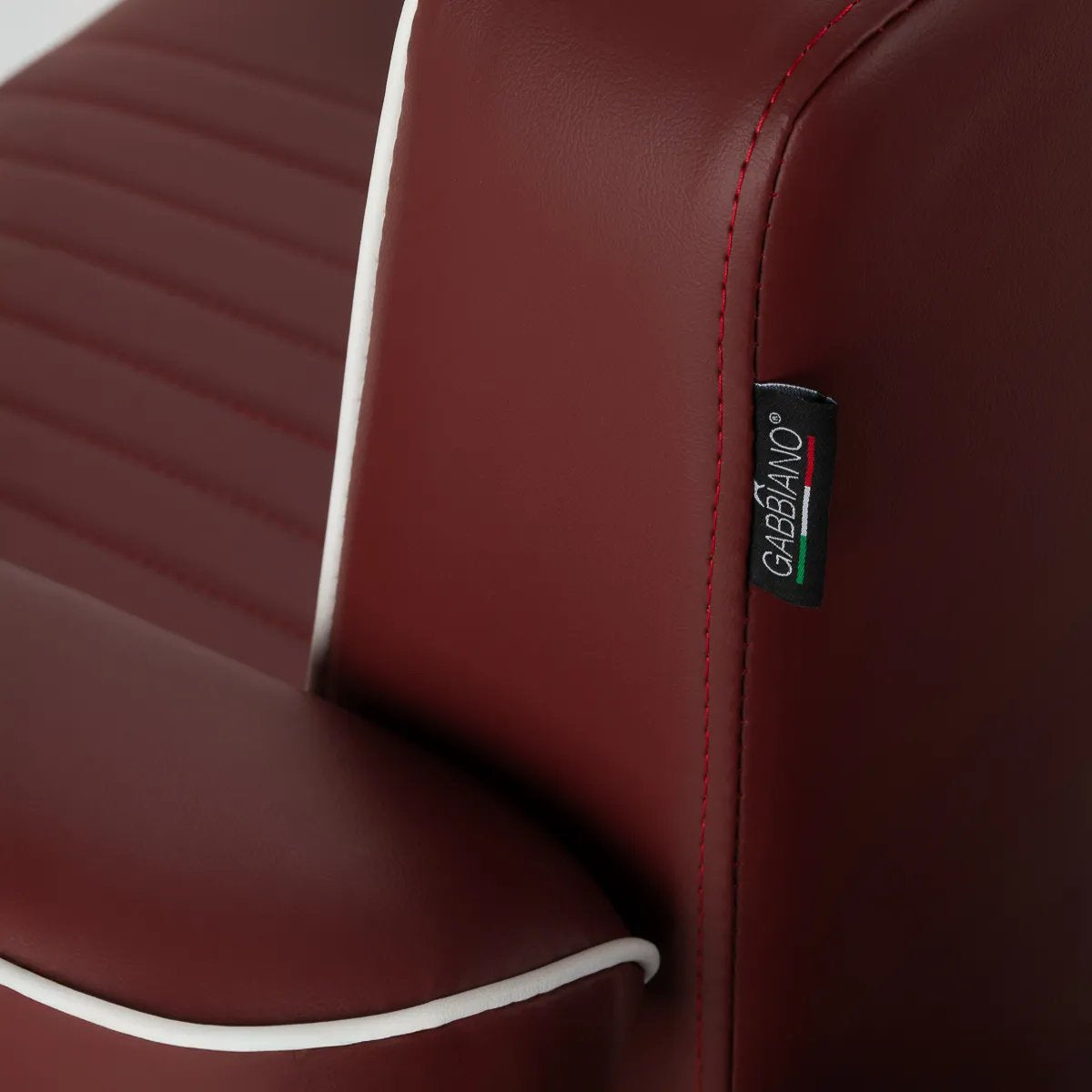 Gabbiano brand badge on the red barber chair upholstery