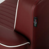 Gabbiano brand badge on the red barber chair upholstery