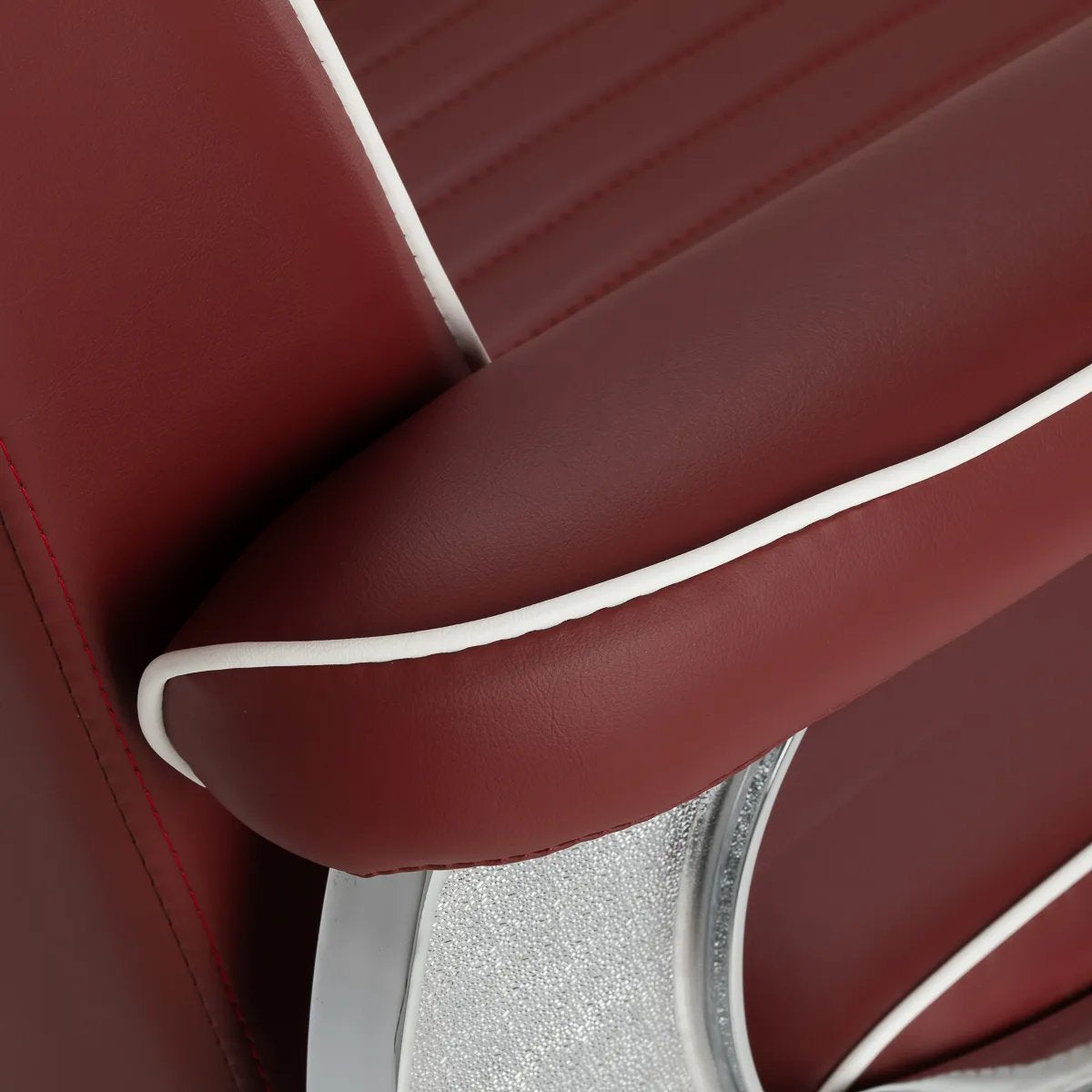 Close-up of the red upholstered armrest with white piping