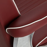 Close-up of the red upholstered armrest with white piping