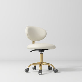 Manufakturo Aura Gold Legs Beauty Stool Creamy - displayed in a professional treatment-room setting
