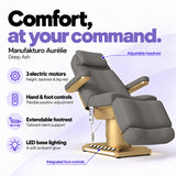 Manufakturo Aurélie Deep Ash electric beauty bed with 3 motors, hand and integrated foot controls, extendable footrest, adjustable headrest and LED base lighting.