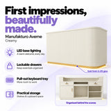 Manufakturo Averne Creamy reception desk with LED base lighting, lockable drawers, pull-out keyboard tray and shelves and cupboard storage.