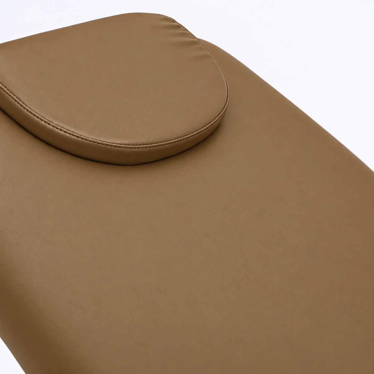 Manufakturo Chérie Caramel electric massage bed — close-up of the removable headrest pillow and upholstery.