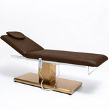 Manufakturo Chérie Cocoa Mocha electric massage bed — full product studio view with raised backrest and gold base.