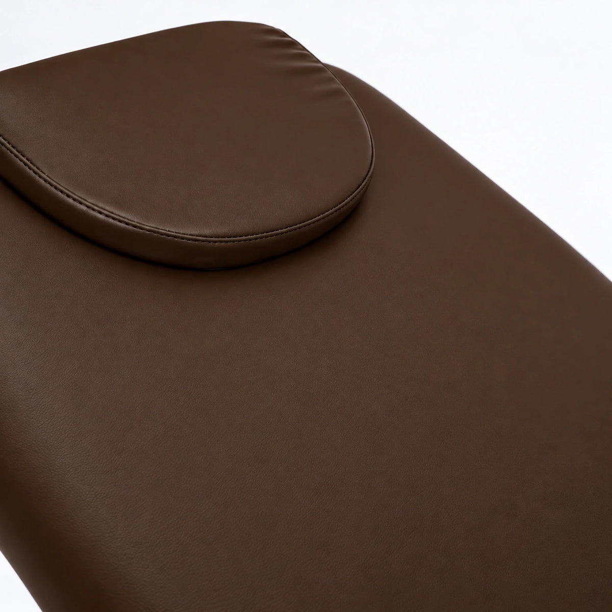 Manufakturo Chérie Cocoa Mocha electric massage bed — close-up of the removable headrest pillow and upholstery.