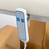 Manufakturo Chérie Creamy electric massage bed — close-up of the two-button hand-held height control and upholstery.