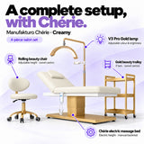 Manufakturo Chérie Creamy salon set features: electric bed height and manual backrest adjustment, height-adjustable rolling chair, V3 Pro Gold lamp with adjustable colour and brightness, and three-tier gold trolley.