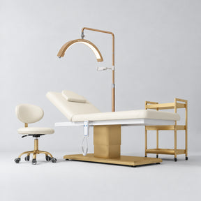 Manufakturo Chérie Creamy four-piece salon set with electric massage bed, matching rolling beauty chair, V3 Pro Gold treatment lamp and empty three-tier gold trolley.
