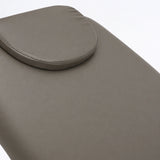 Manufakturo Chérie Deep Ash electric massage bed — close-up of the removable headrest pillow and upholstery.