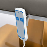 Manufakturo Chérie Deep Ash electric massage bed — close-up of the two-button hand-held height control and upholstery.