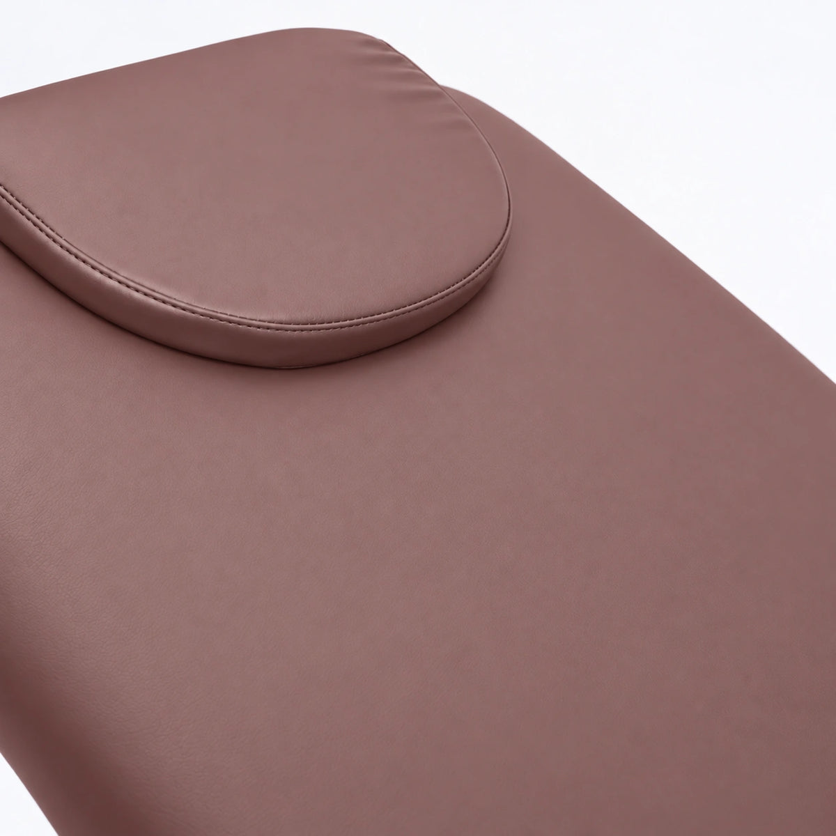 Manufakturo Chérie Dusty Rose electric massage bed — close-up of the removable headrest pillow and upholstery.